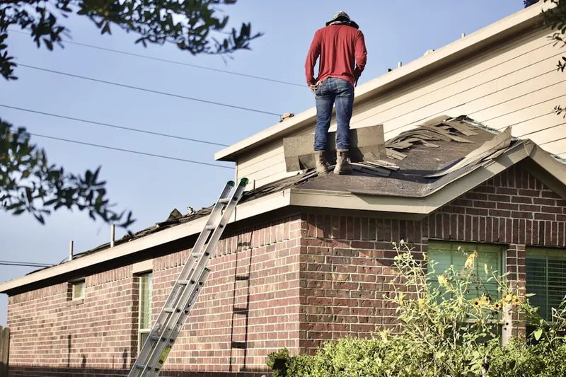 Professional roofer working on a residential roof in Flat Rock Forest